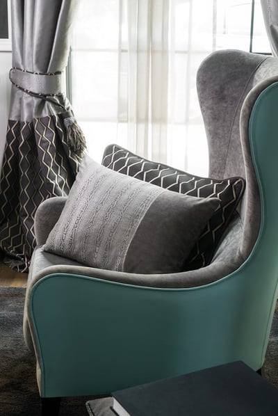 FR dimout curtain fabric in front of a statement green armchair_aten collection